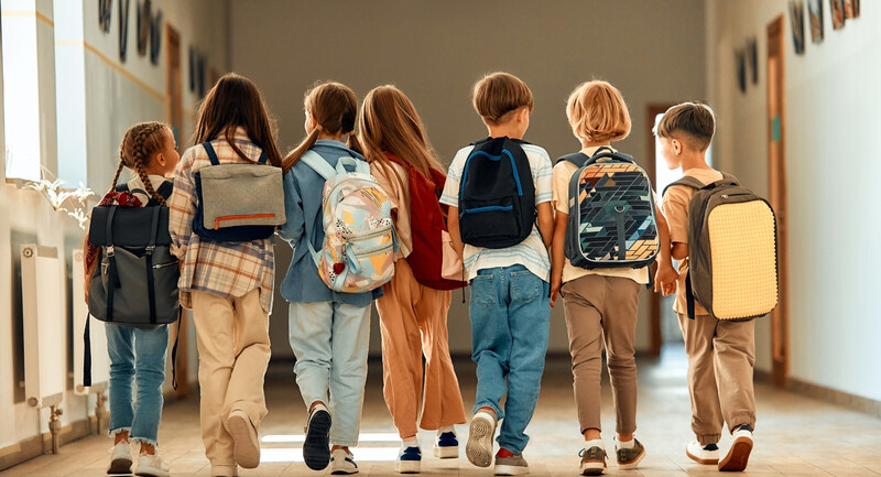 An ombre background featuring the Summer 2024 issue of EL Magazine titled "From Absent to Engaged," with a line of backpacks increasing in saturation as they progress.